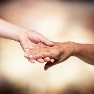 Two people holding hands in a close up picture.